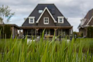 white and black house near to pond by Wynand van Poortvliet courtesy of Unsplash.